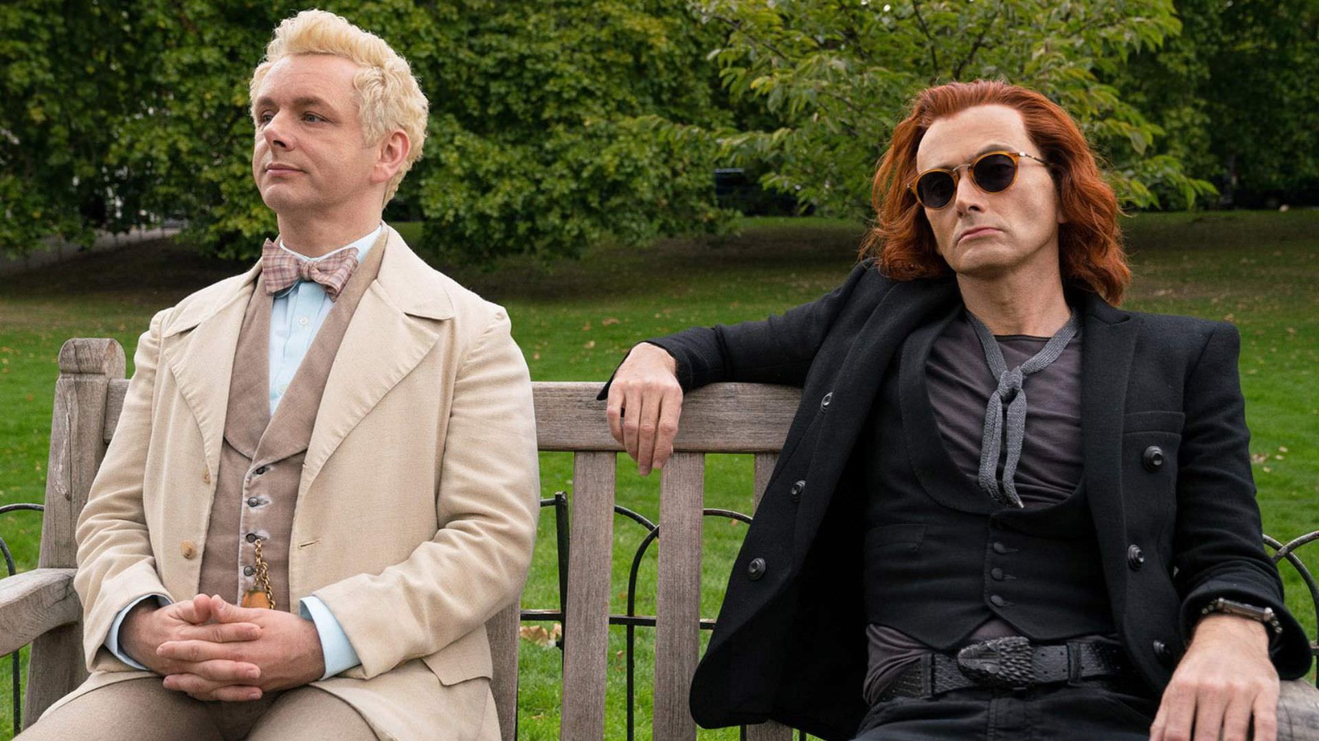 good-omens-michael-sheen-as-aziraphale-david-tennant-as-crowley-sit-in-park